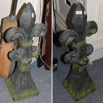 Lot 1181 - Pair of composition fleur de lys garden ornament, with artificial weathering, 86cm high