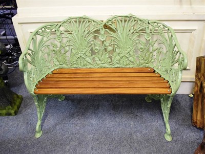 Lot 1185 - A green painted Coalbrookedale style cast iron and wooden slatted garden bench