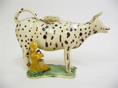 Lot 156 - A Staffordshire Pottery Cow Creamer, circa 1800, the standing beast with manganese dot...