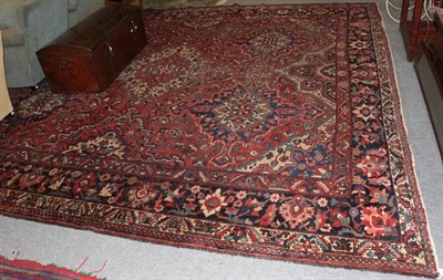 Lot 1231 - Bakhtiari carpet, of unusual size, the madder field with columns of medallions enclosed by...