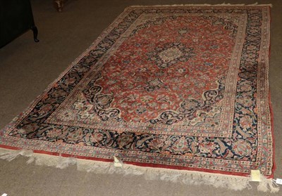 Lot 1245 - Indian carpet of Kashan design, the terracotta field of vines centred by an indigo medallion framed