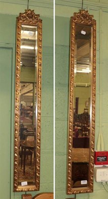 Lot 1269 - Pair of modern gilt framed bevel glass mirrors of narrow form, 120cm by 18cm