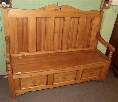 Lot 1270 - A stained pine box settle (modern), the base with three dummy drawers, 152cm by 47cm by 116cm