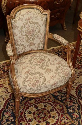 Lot 1318 - A Louis XVI Style Carved Giltwood Fauteuil, mid 19th century, upholstered in close-nailed...