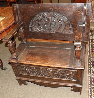 Lot 1348 - An early 20th century carved oak monks bench