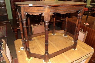 Lot 1363 - An oak centre table, 20th century, of octagonal shaped form with moulded frieze, on gun barrel...