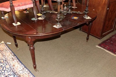 Lot 1367 - A 19th century mahogany wind out dining table, with two additional leaves, on reeded legs