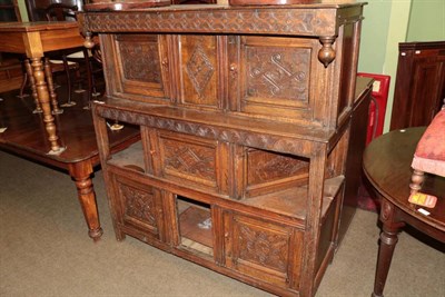 Lot 1369 - An early 18th century joined oak press cupboard with carved cupboard doors