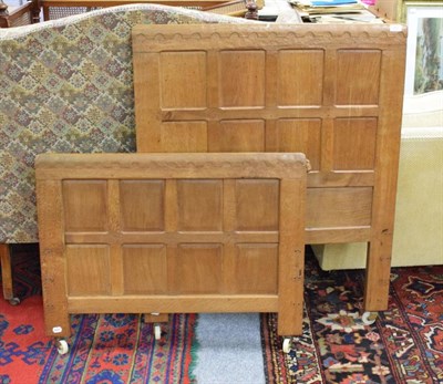 Lot 1385 - Mouseman: a Robert Thompson of Kilburn panelled English oak 3ft single bedstead, the headboard...