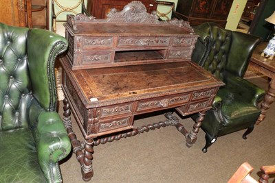 Lot 1388 - A Victorian carved oak desk with superstructure back, raised on spiral turned legs