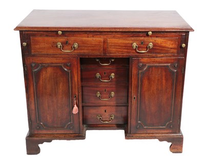 Lot 752 - A George III Mahogany Kneehole Desk, circa 1760, the moulded top with a pull-out slide above...