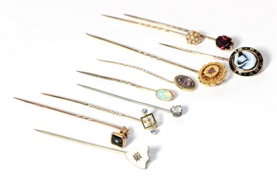 Lot 165 - Ten gold and gilt metal stick pins including opal set, seed pearl set, diamond set and mourning...