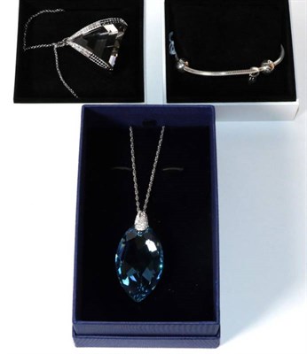 Lot 179 - A Pandora bracelet in original box and two Swarovski pendants on chains