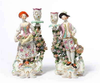 Lot 181 - A Pair of Derby Candlestick Figures, circa 1765, depicting a girl with an apron full of summer...