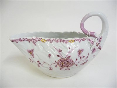 Lot 184 - A Derby Cabbage Leaf Moulded Sauceboat, circa 1760, with stalk loop handle, painted in purple...