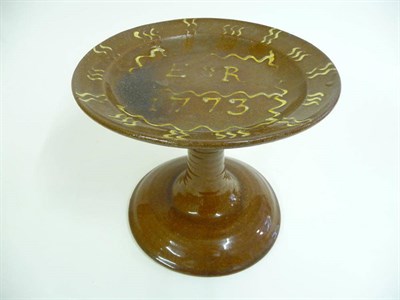 Lot 186 - A Slipware Ham Stand, dated 1773, the circular dished top inscribed ER 1773 and with scrolling...
