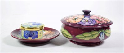 Lot 255 - A Moorcroft pottery Pansy pattern circular box and cover on a red ground with impressed marks, 14cm