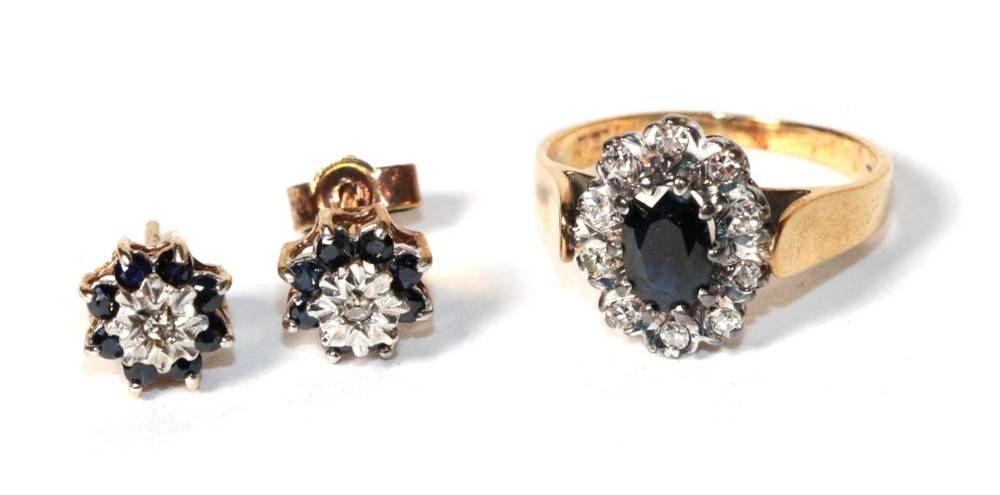 Lot 268 - A diamond and sapphire cluster ring, stamps rubbed, finger size K; and a similar pair of earrings
