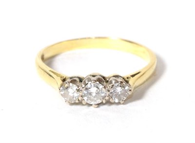 Lot 301 - An 18 carat gold three stone diamond ring, finger size Q