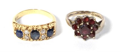Lot 324 - A sapphire and diamond ring, stamped '18CT', finger size N1/2; together with a silver garnet...