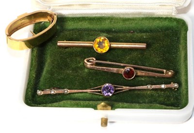 Lot 329 - A scarf ring, stamped '15CT'; two bar brooches stamped '9CT'; and a bar brooch stamped '9'...