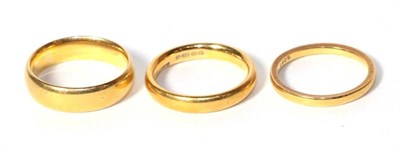 Lot 331 - Three 22 carat gold band rings, one boxed, finger sizes N, O and O