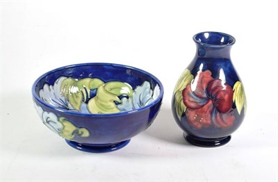 Lot 354 - A Moorcroft pottery Hibiscus pattern bowl on a blue ground with painted and impressed marks,...