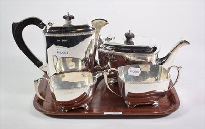 Lot 368 - A four piece silver teaset, by S & W, Sheffield 1943, of plain oblong form, with ebonised...
