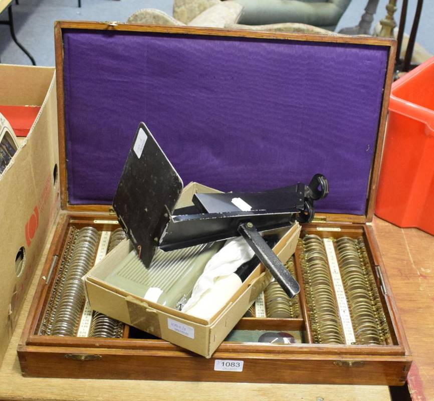 Lot 1083 - A small group of ophthalmic equipment including an oak cased set of lenses and an ophthalmoscope