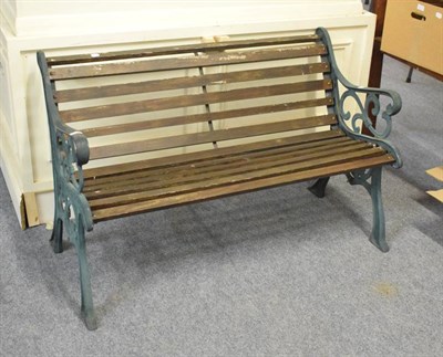 Lot 1145 - A wooden slatted garden bench