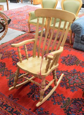 Lot 1146 - A pine rocking chair