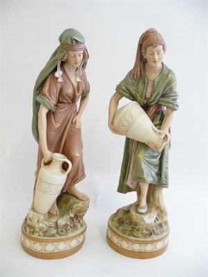 Lot 225 - A Pair of Royal Dux Bisque Porcelain Figures of Water Carriers, early 20th century, as a boy...