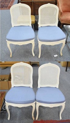 Lot 1152 - A set of four white painted cane backed and seated chairs, in the French style