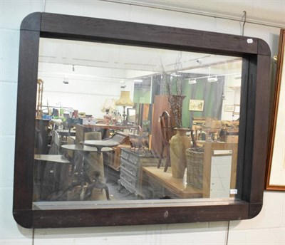 Lot 1180 - A large wall mirror in wooden frame