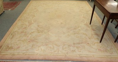 Lot 1181 - An Oriental style carpet, with floral decorated cream ground, within salmon borders
