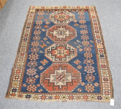 Lot 1183 - A Kazak rug, Central Caucasus, the indigo with four 'Memling' guls enclosed by stellar motif...