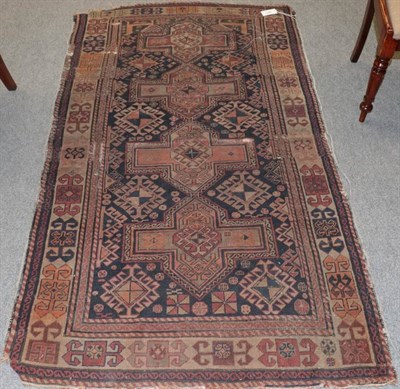 Lot 1188 - Shirvan rug, the field with a row of cuciform medallions enclosed by ivory borders, 193cm by 110cm