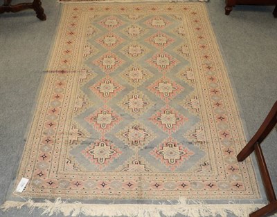Lot 1193 - Indian 'Bukhara' Rug, the dove grey field with two columns of diamond medallions enclosed by narrow