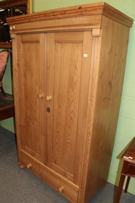 Lot 1207 - Pine double door wardrobe, the base with a long drawer