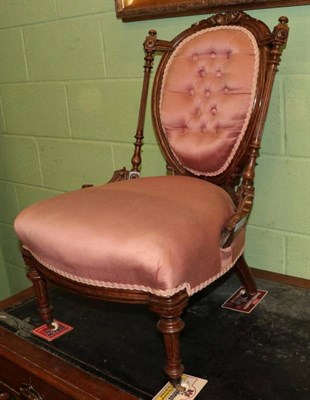 Lot 1209 - Victorian walnut and parcel gilt nursing chair, recovered in pink fabric