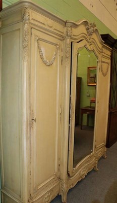 Lot 1211 - A 19th century French cream painted triple door wardrobe, 230cm by 47cm by 243cm high