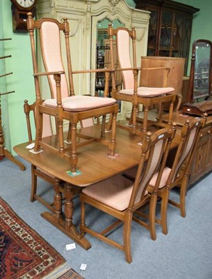 Lot 1214 - An Ercol ash extending dining table, with two additional leaves, on turned bulbous legs with sledge