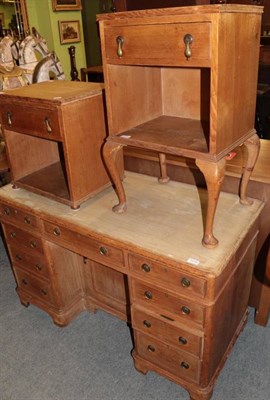Lot 1215 - A 19th century stripped pine kneehole desk; and two pine bedside tables (all with glass protectors)
