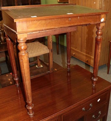 Lot 1225 - A mahogany leather inset writing desk with carved tapering legs
