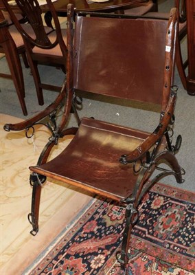 Lot 1234 - An early 20th century leather and metal cross frame chair, 61cm by 67cm by 94cm