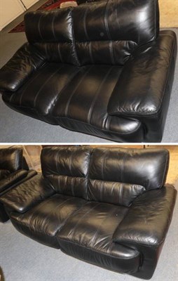 Lot 1254 - A pair of black leather two-seater sofas, modern, with padded arms, on polished metal feet,...