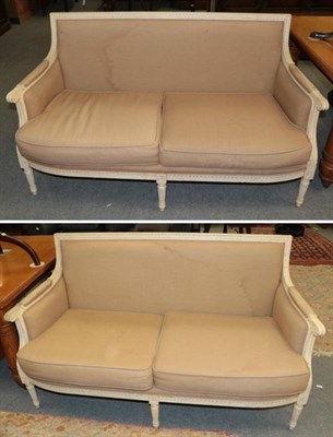 Lot 1262 - A pair of cream painted two-seater sofas, modern, covered in light brown cotton fabric, with padded
