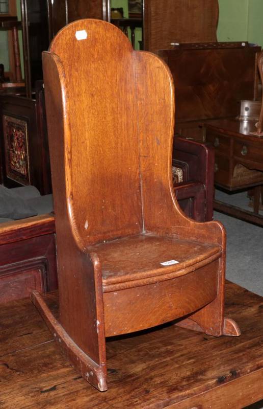 Lot 1265 - A 19th century oak childs commode rocking