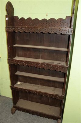 Lot 1278 - A carved freestanding bookcase raised on sledge feet, 83cm by 30cm by 172cm