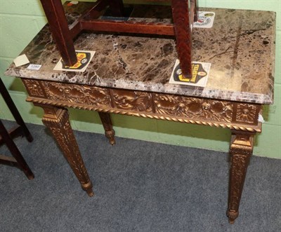 Lot 1280 - A gilt side table (modern), with marble top and acanthus decorated tapering legs, 74cm by 41cm...